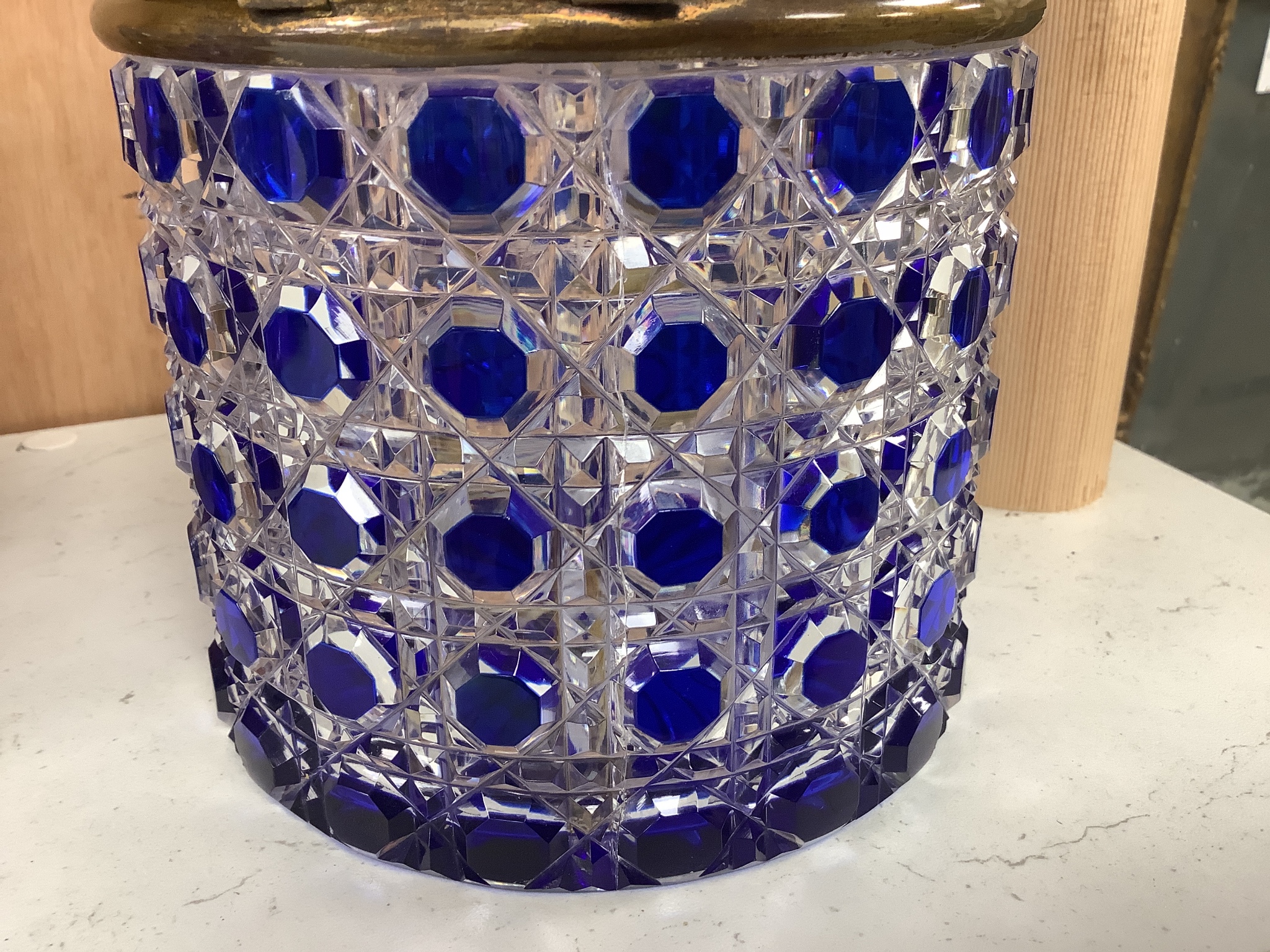 A 19th century Bohemian overlaid glass vase, 25.5cm, a similar gilded and enamelled beaker and two blue flashed hobnail glass biscuit boxes and covers